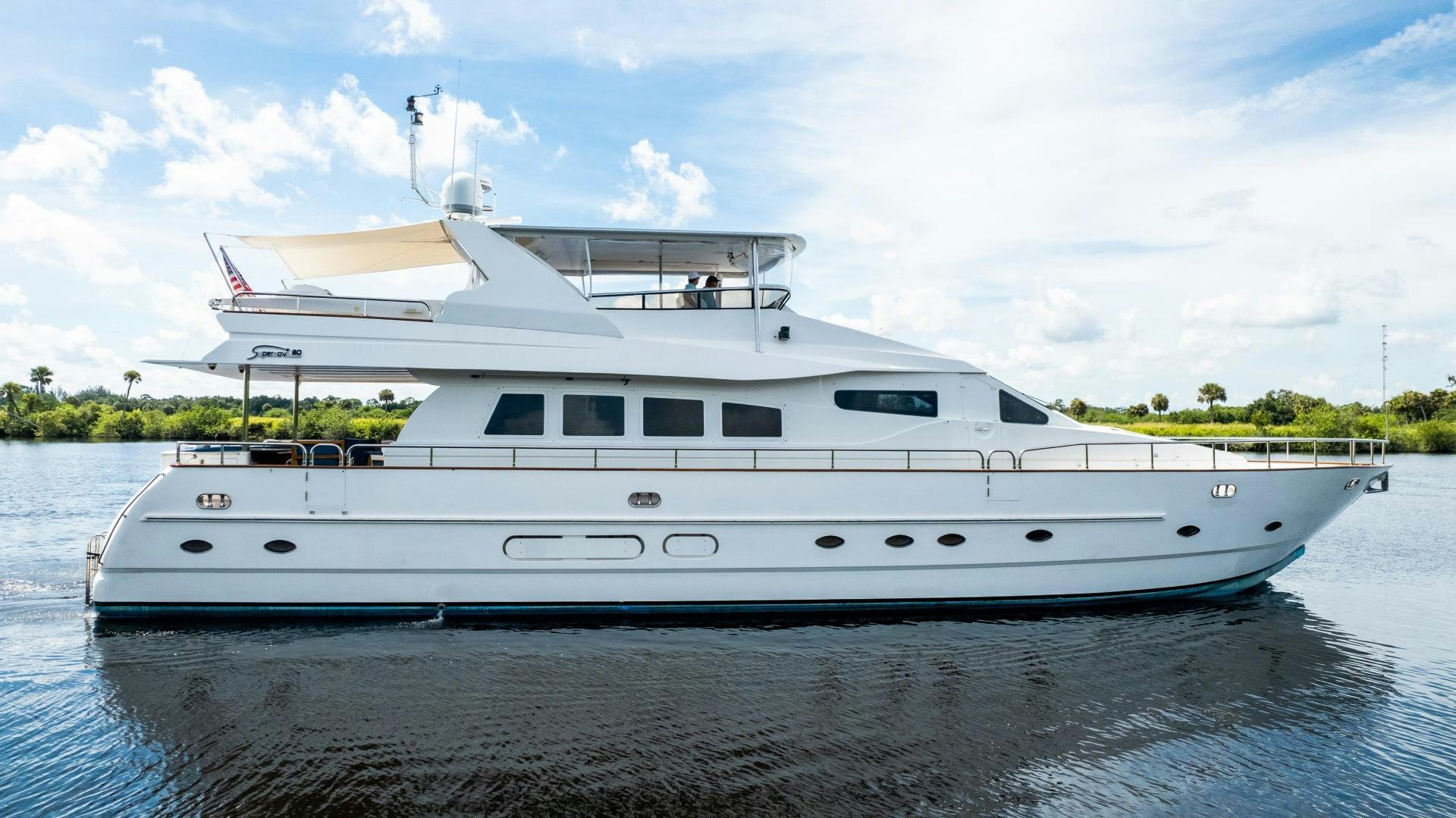 a white yacht on the water aboard DREAMCHASER Yacht for Sale