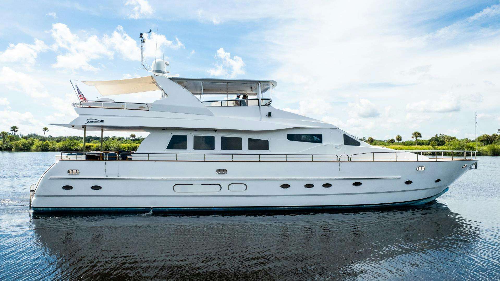 a white yacht on the water aboard DREAMCHASER Yacht for Sale
