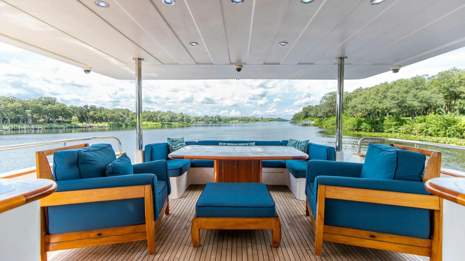 a boat deck with blue seats aboard DREAMCHASER Yacht for Sale