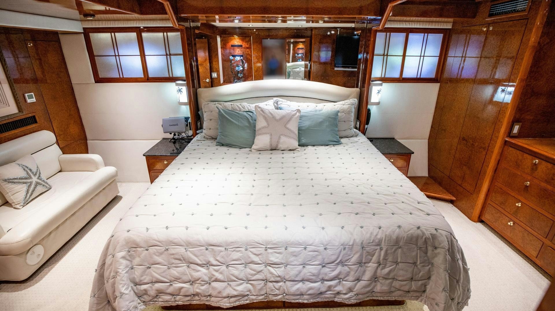 a room with a bed and a couch aboard DREAMCHASER Yacht for Sale
