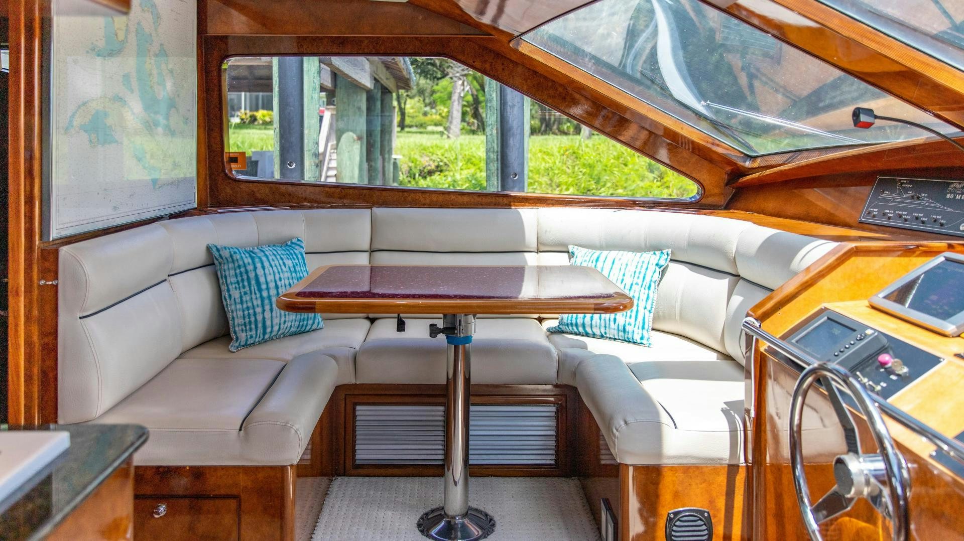 a room with a couch and a table aboard DREAMCHASER Yacht for Sale