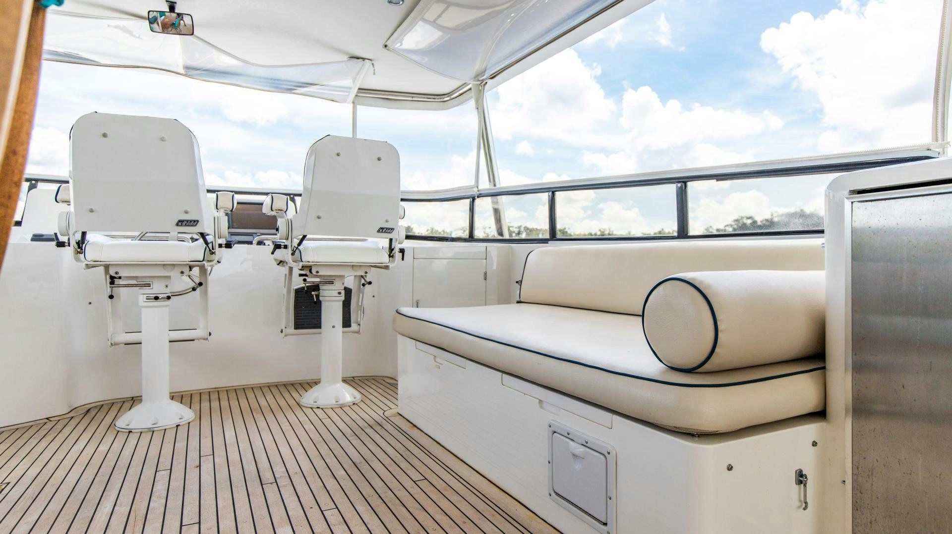 a room with a deck and a deck with a view of the ocean aboard DREAMCHASER Yacht for Sale