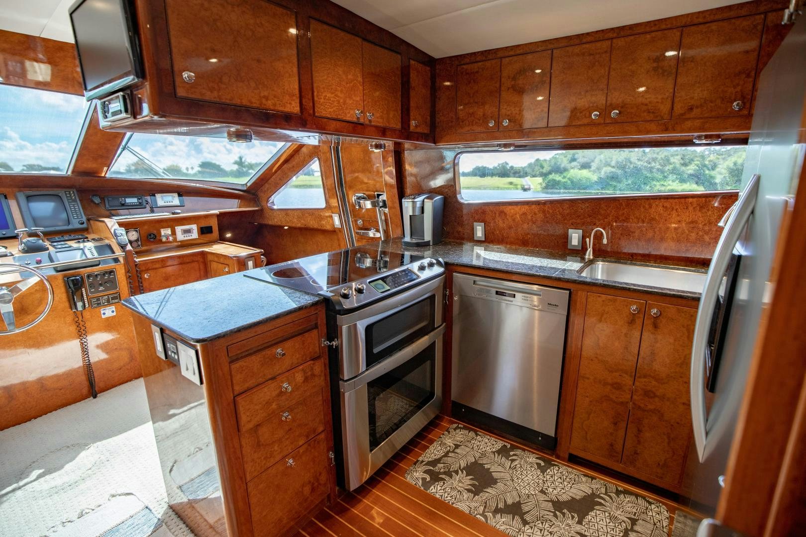 a kitchen with wooden cabinets aboard DREAMCHASER Yacht for Sale