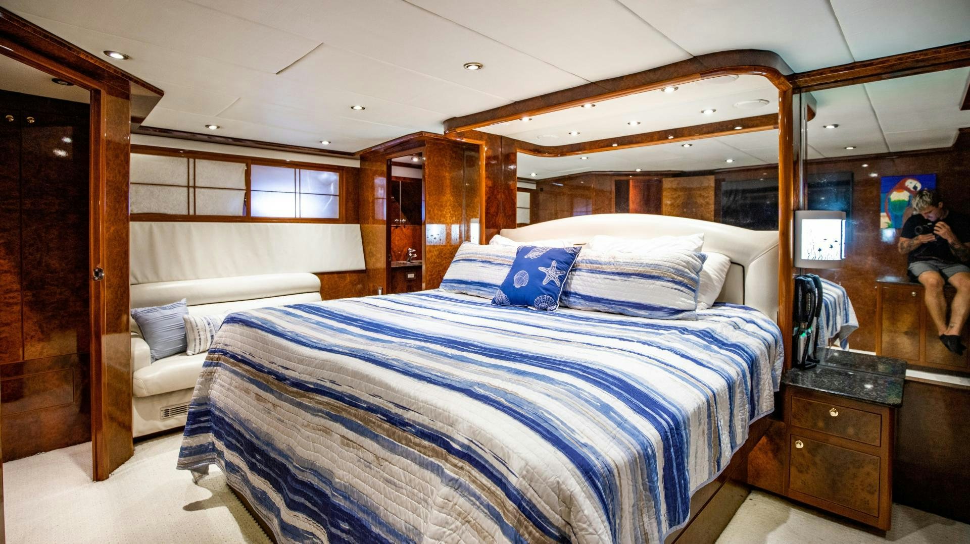 a bedroom with a bed and a mirror aboard DREAMCHASER Yacht for Sale