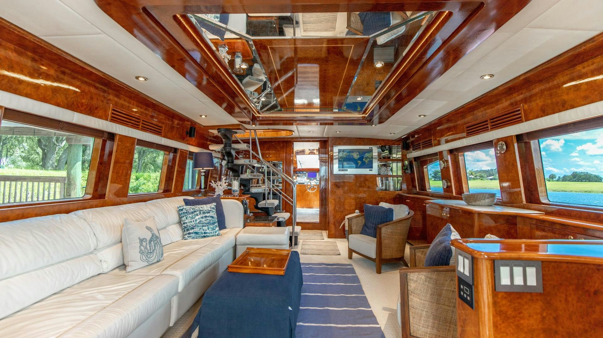 a room with a couch and a table aboard DREAMCHASER Yacht for Sale