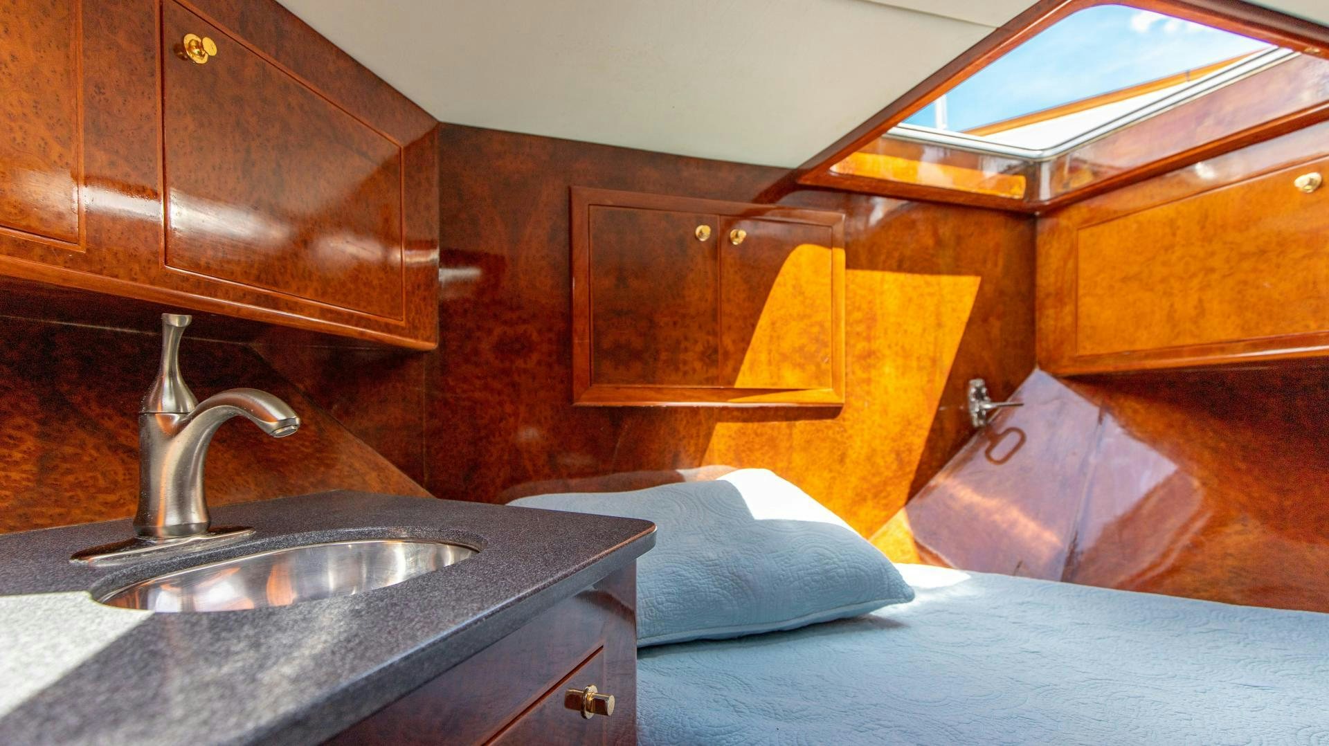 a bed and a sink in a room aboard DREAMCHASER Yacht for Sale