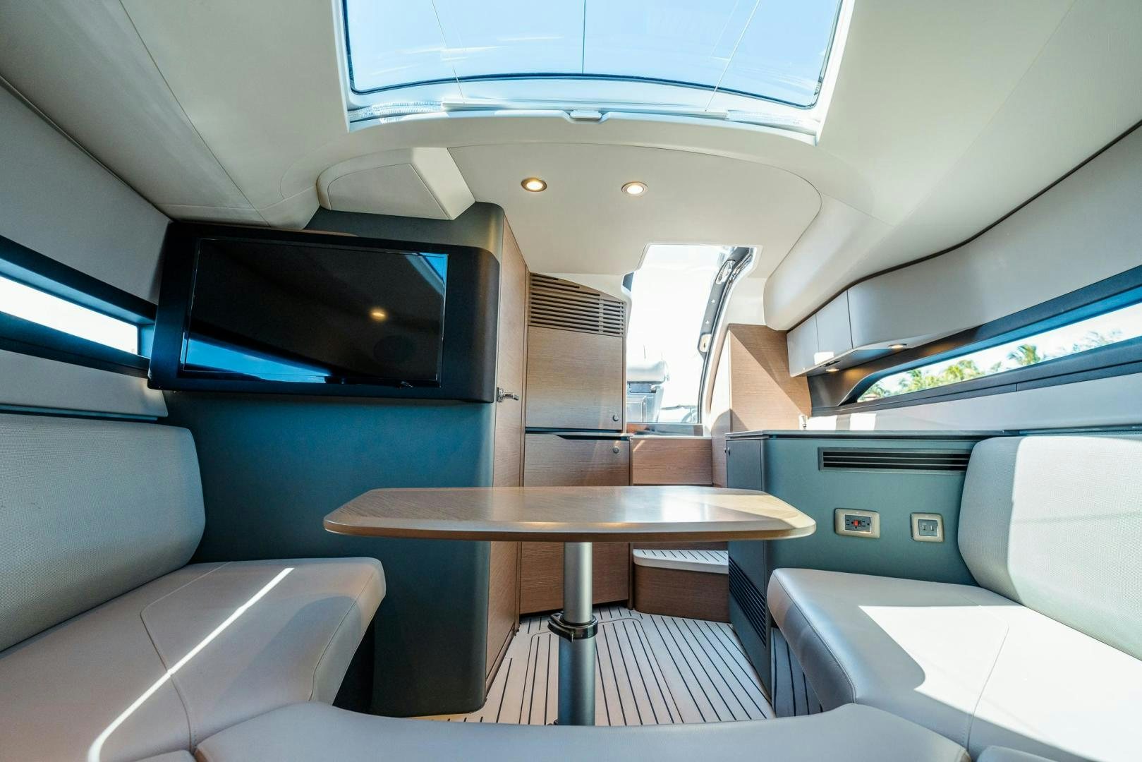 inside of a vehicle with a table and chairs aboard PR35 Yacht for Sale