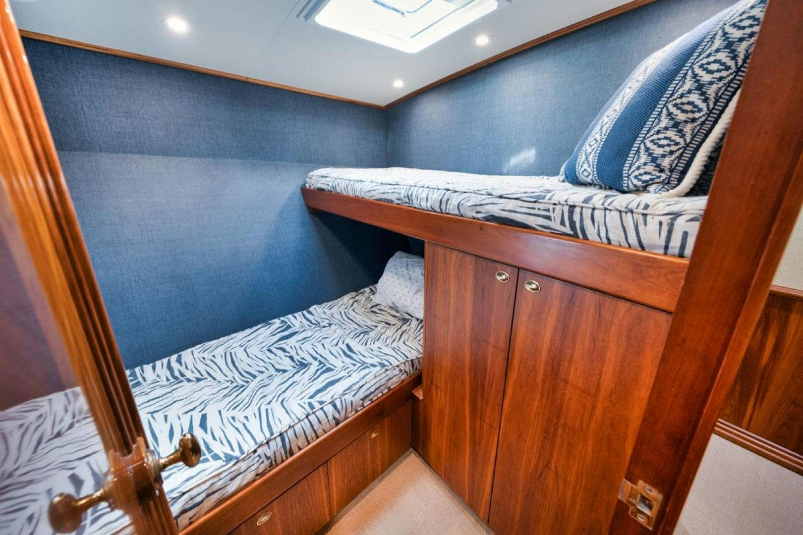 a bed with a wooden headboard aboard Gina Lisa Yacht for Sale