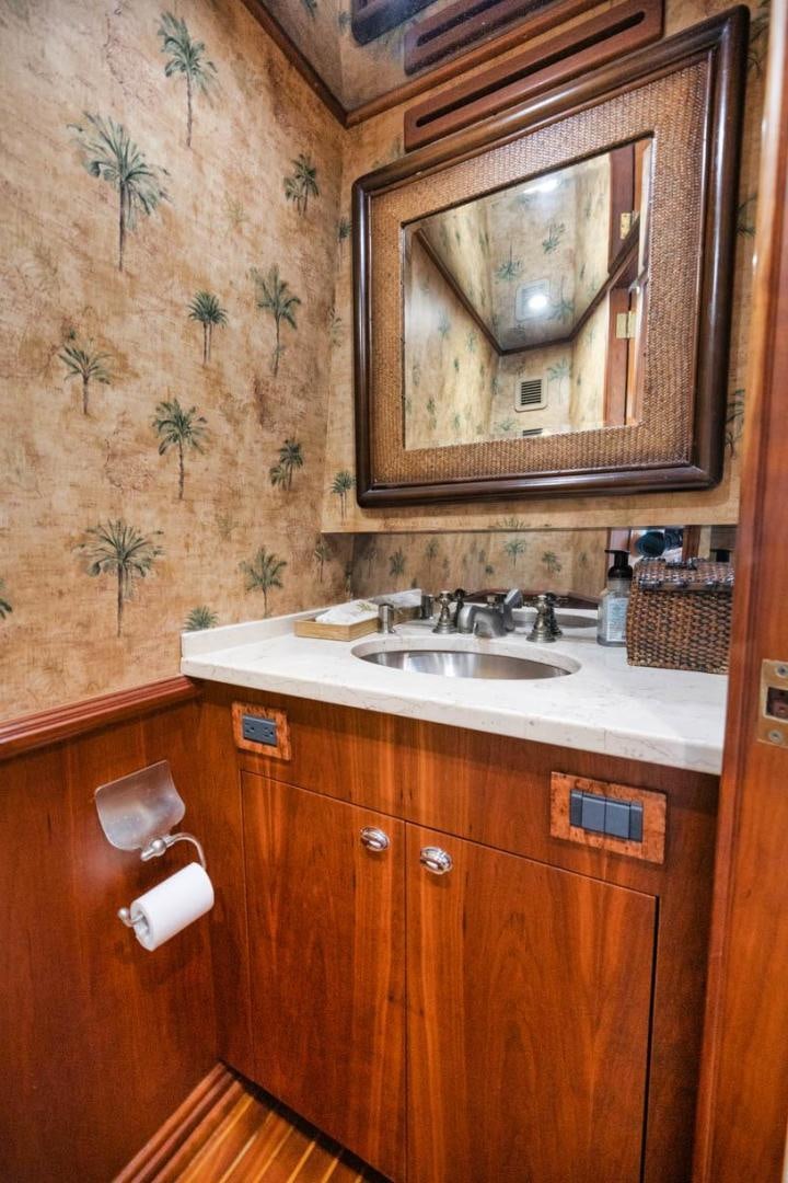 a bathroom with a mirror and a sink aboard Gina Lisa Yacht for Sale