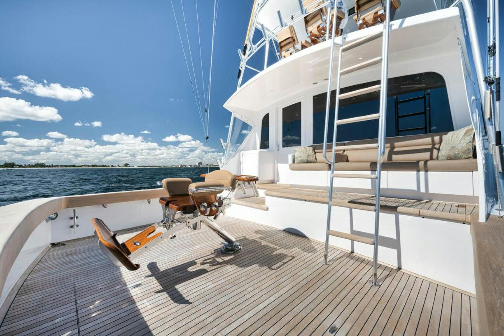 a deck with a chair and a railing on it aboard Gina Lisa Yacht for Sale
