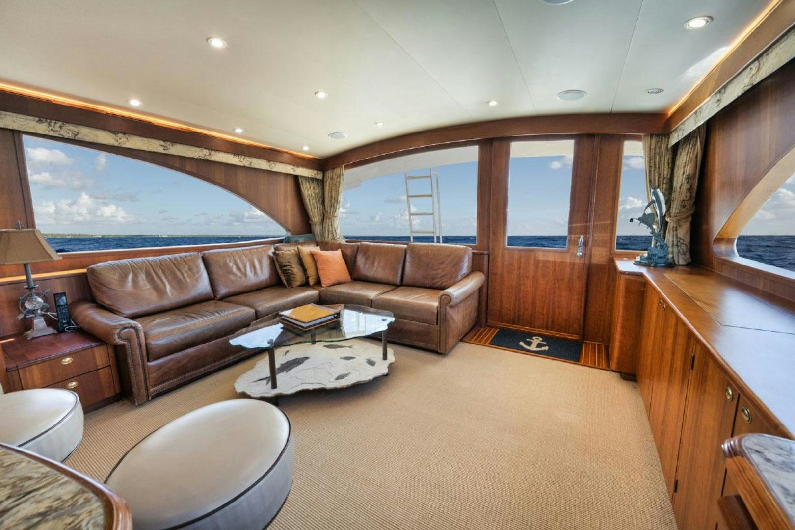a living room with a leather couch aboard Gina Lisa Yacht for Sale