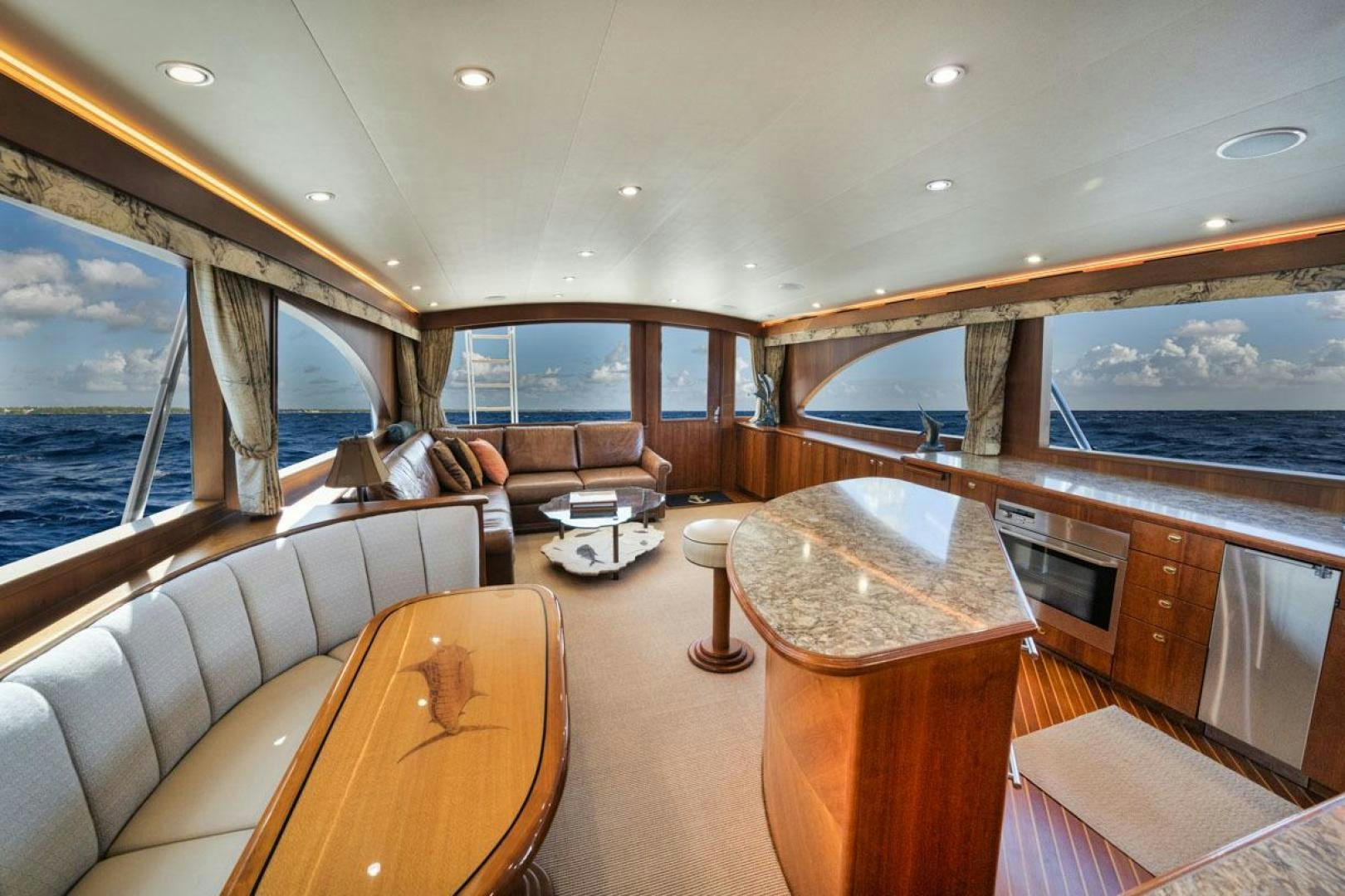 a living room with a large window aboard Gina Lisa Yacht for Sale