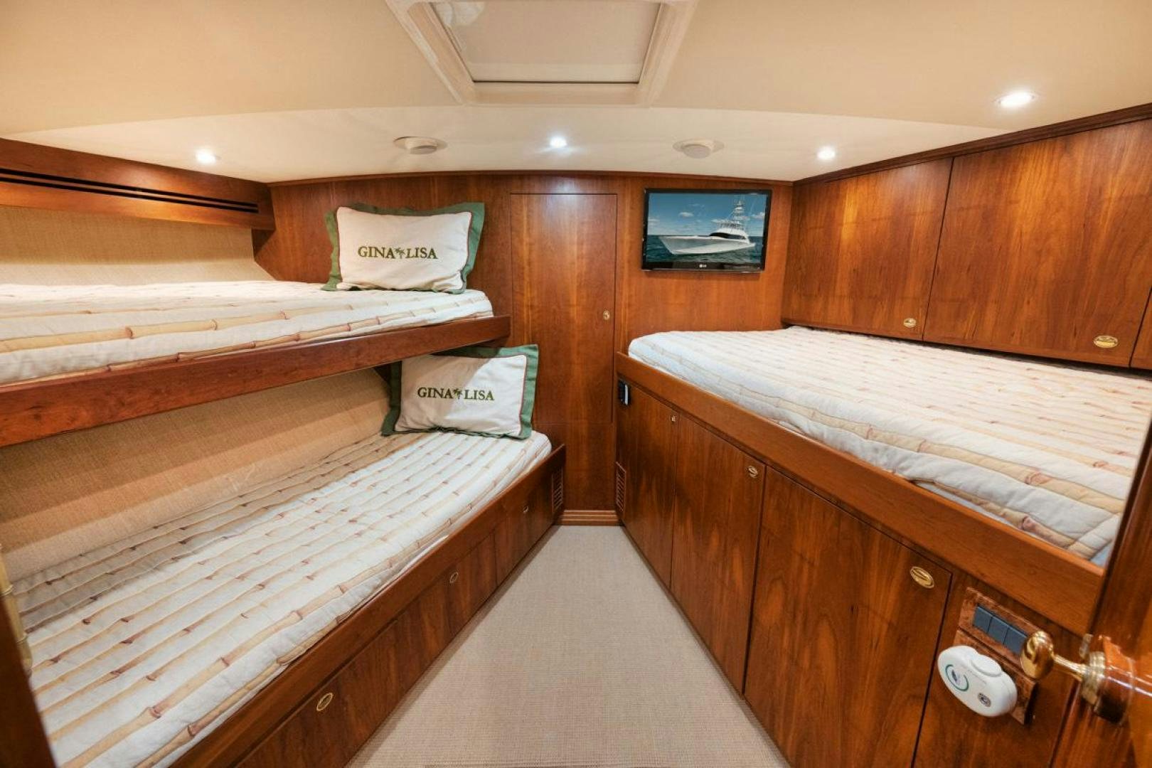 a room with wooden bunk beds aboard Gina Lisa Yacht for Sale