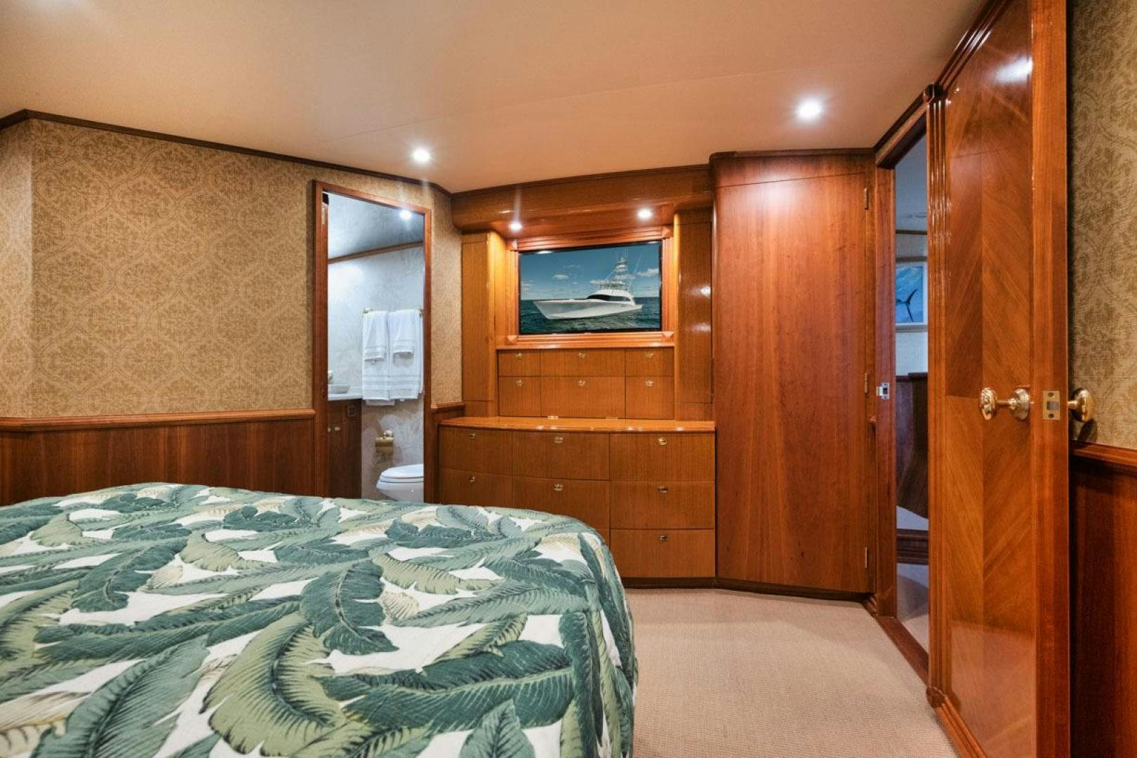 a bedroom with a bed and a television aboard Gina Lisa Yacht for Sale