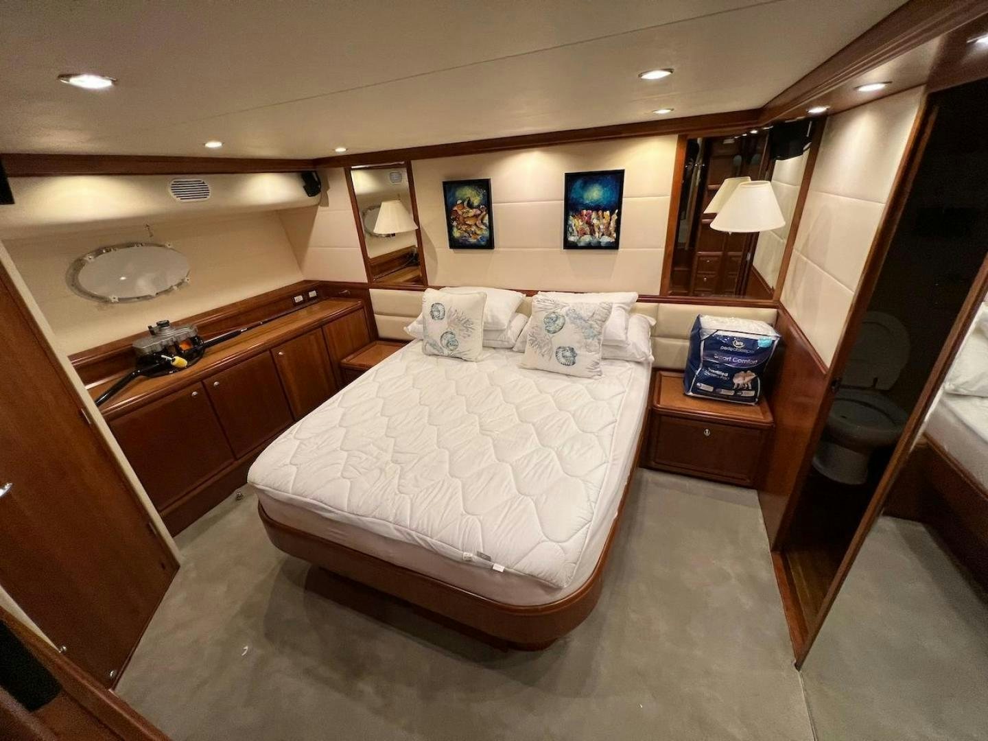 a bedroom with a bed and a dresser aboard ROFO Yacht for Sale