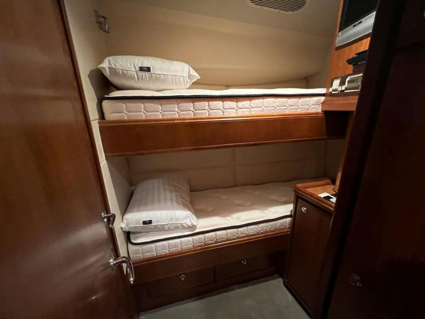 a bed with a white pillow aboard ROFO Yacht for Sale