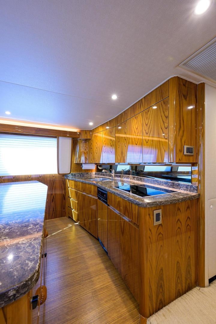 a kitchen with wooden cabinets aboard TORO Yacht for Sale