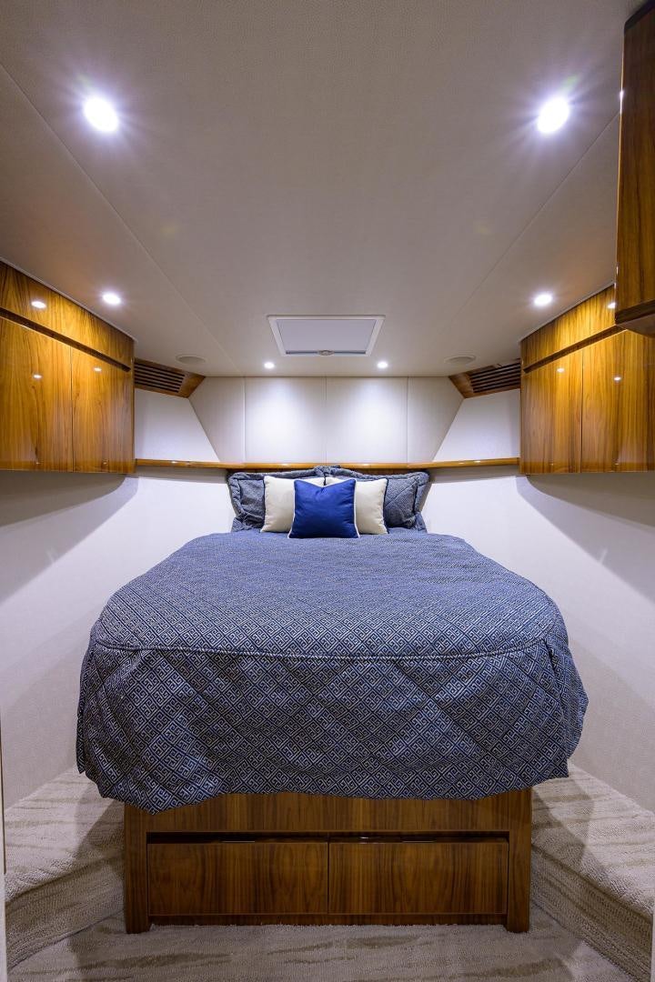 a bed with a blue blanket aboard TORO Yacht for Sale