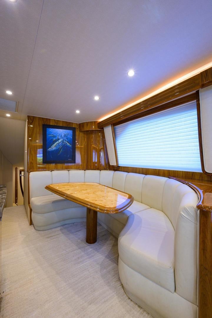 a living room with a table and couches aboard TORO Yacht for Sale