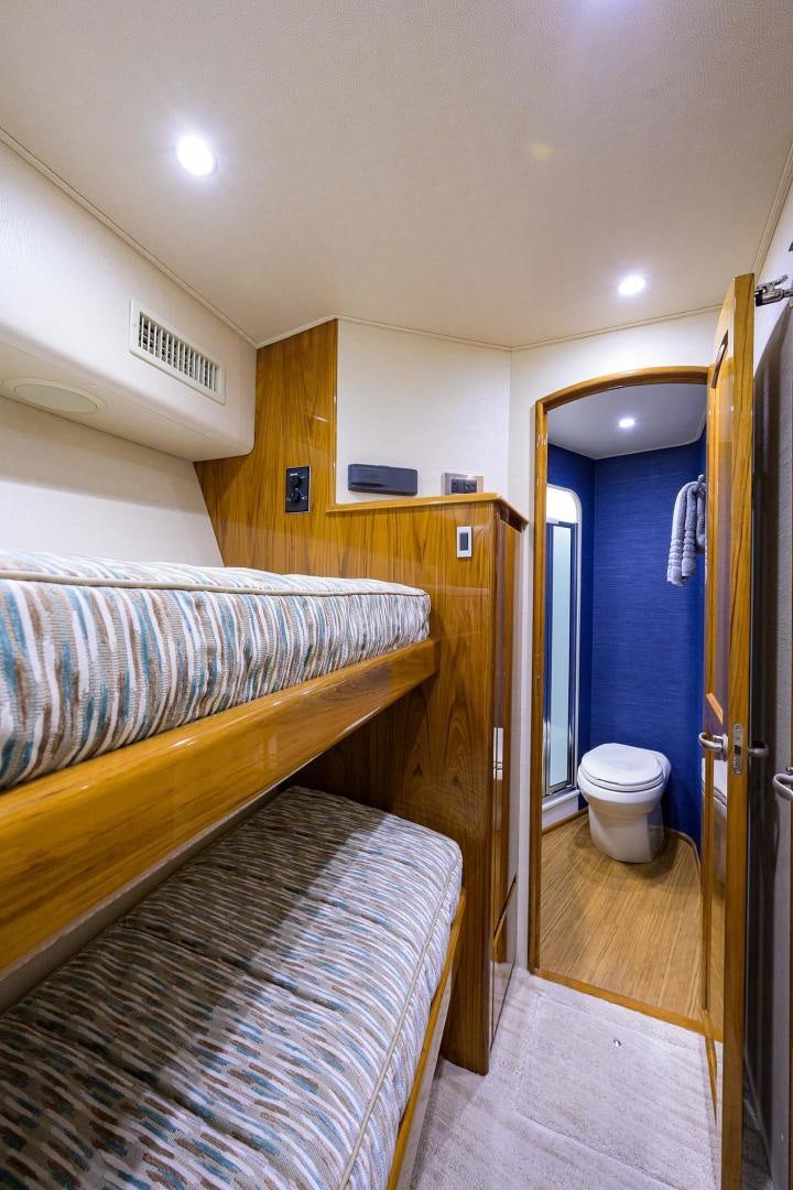 a small bedroom with a bunk bed aboard TORO Yacht for Sale