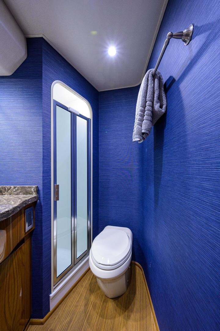 a bathroom with a toilet and a sink aboard TORO Yacht for Sale