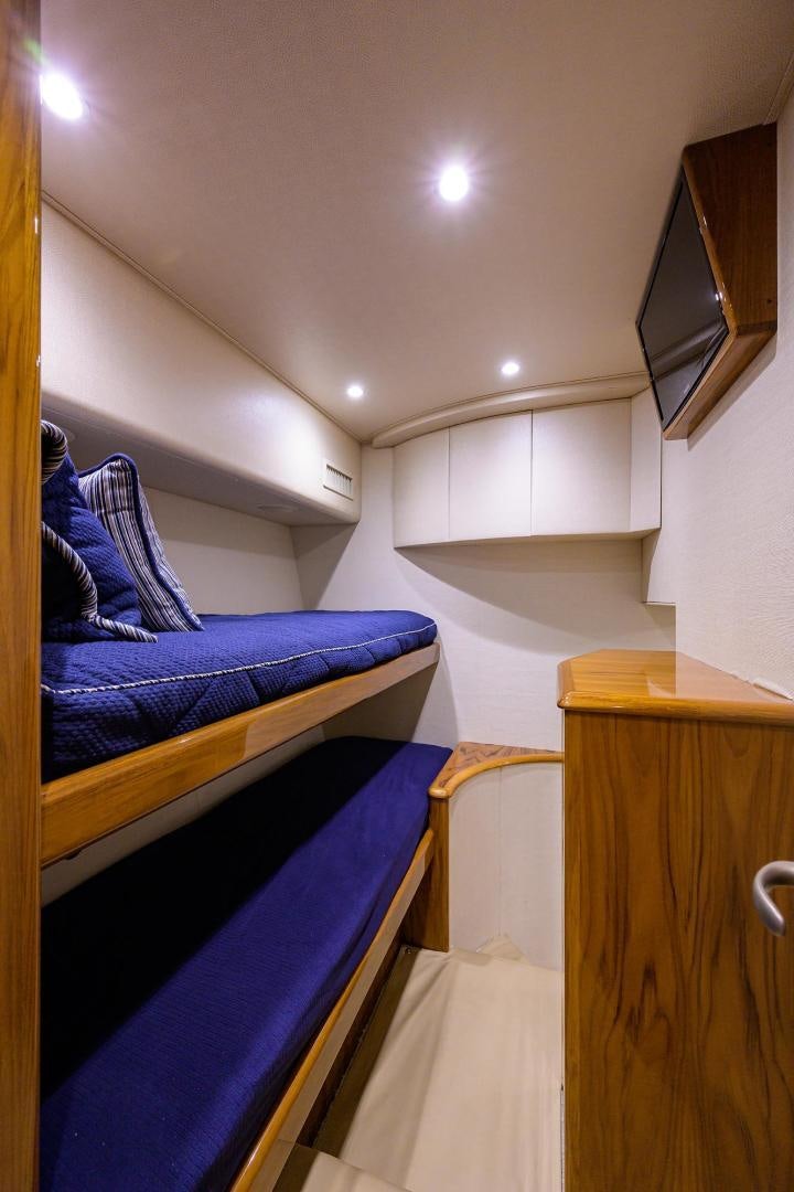 a room with a bed and a desk aboard TORO Yacht for Sale