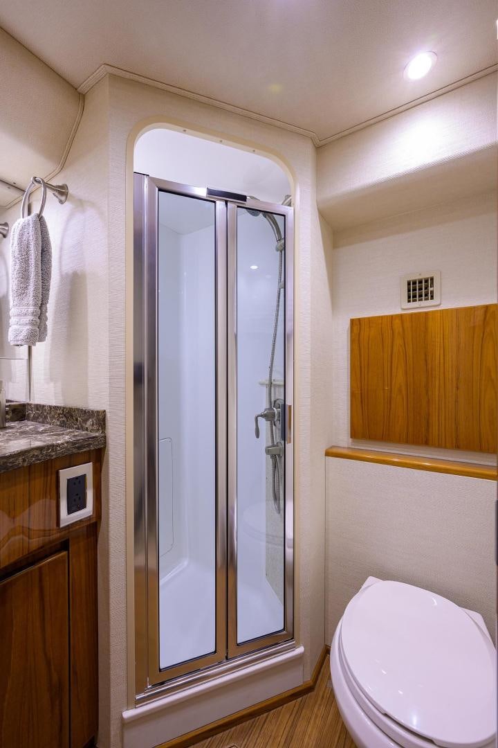a bathroom with a glass shower door aboard TORO Yacht for Sale