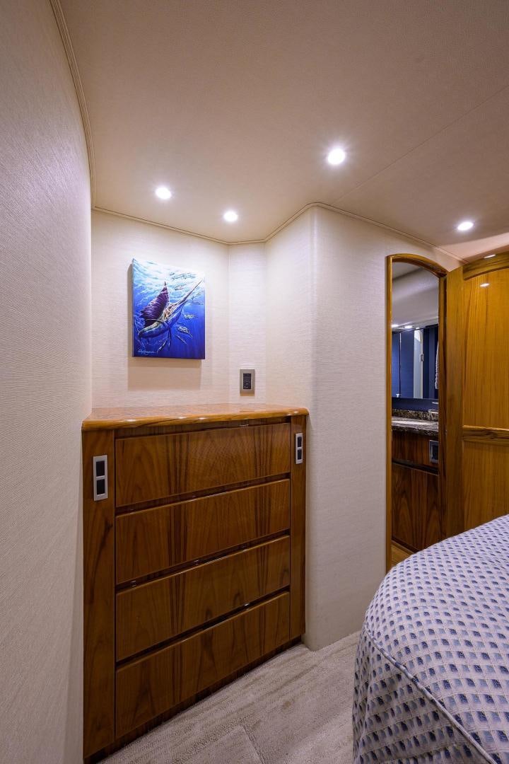 a bedroom with a bed and a dresser aboard TORO Yacht for Sale