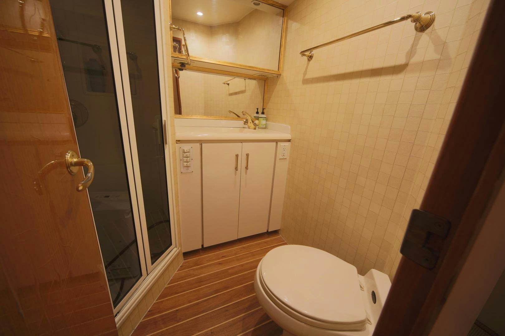 a bathroom with a wood floor aboard LUCILLE Yacht for Sale