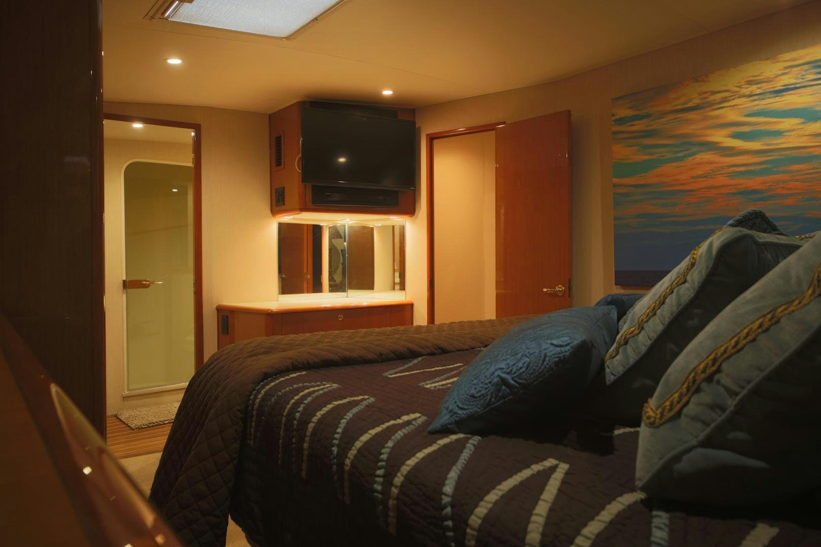 a bedroom with a bed and a television aboard LUCILLE Yacht for Sale