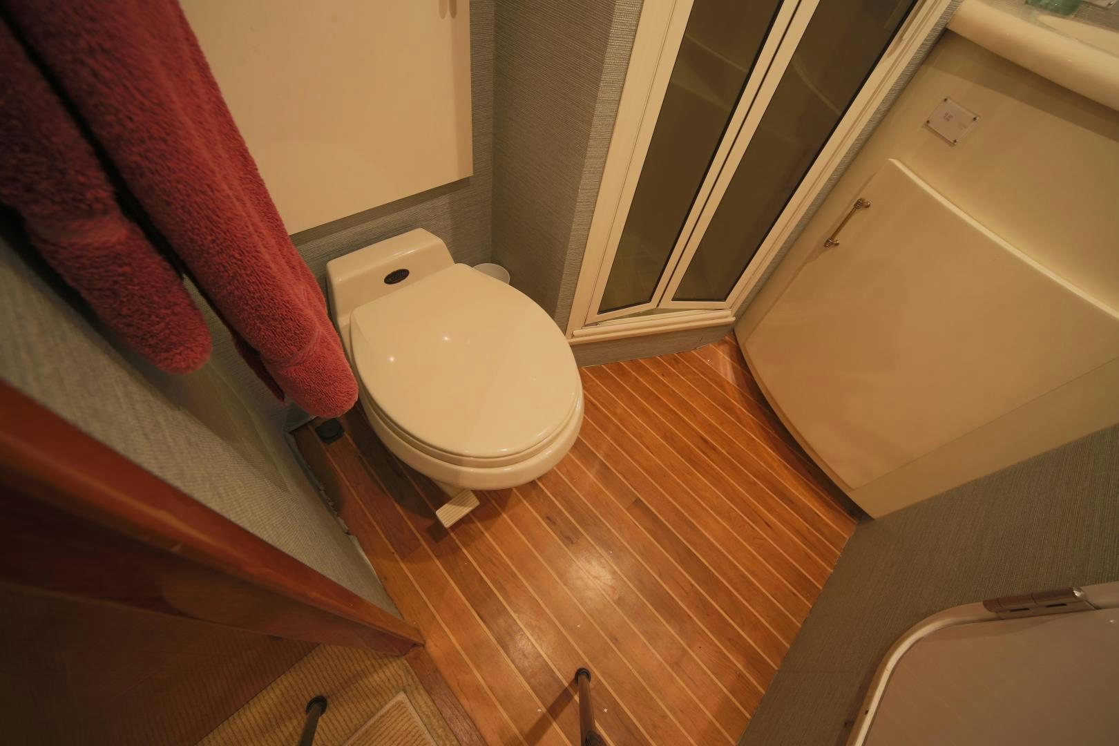a bathroom with a toilet and a sink aboard LUCILLE Yacht for Sale