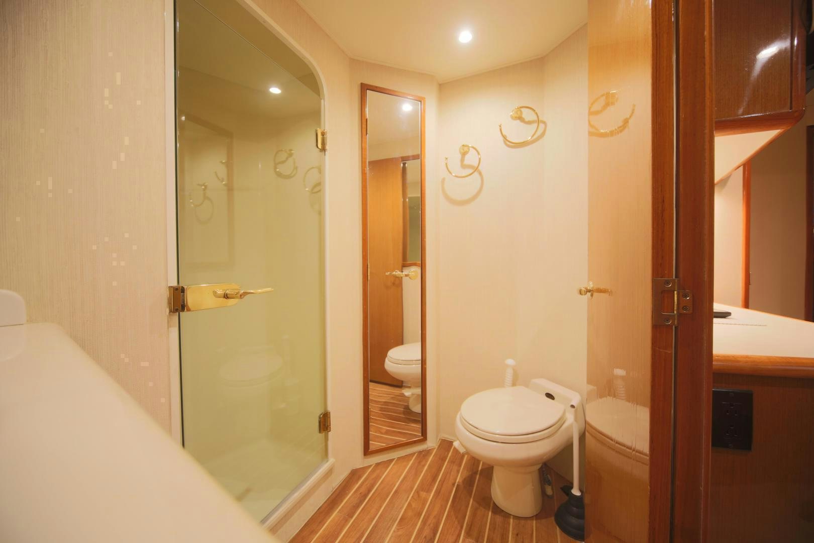 a bathroom with a glass shower door aboard LUCILLE Yacht for Sale
