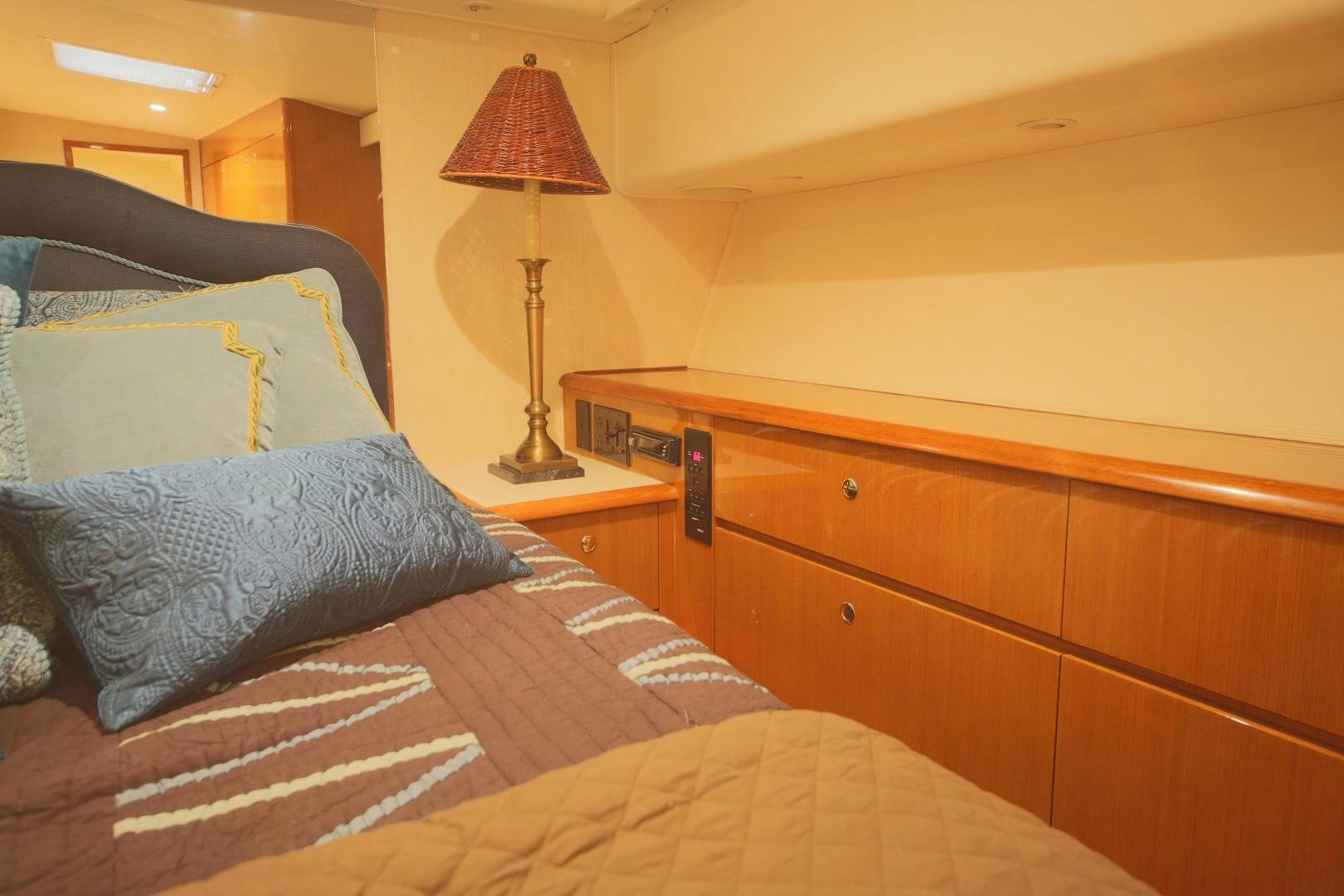 a bed with a lamp on it aboard LUCILLE Yacht for Sale