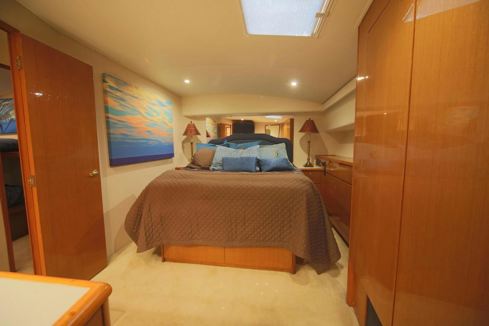 a bedroom with a bed and a desk aboard LUCILLE Yacht for Sale