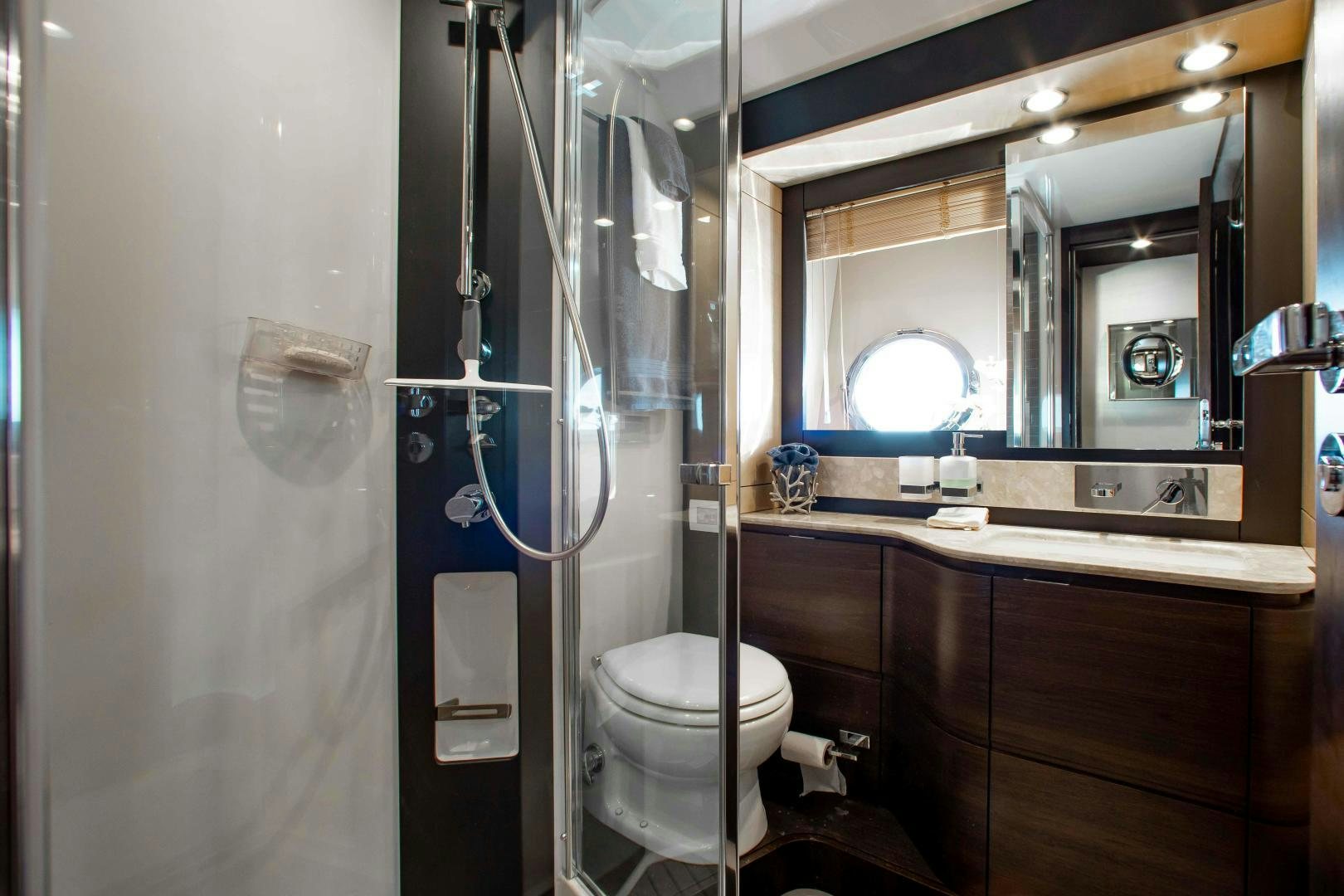 a bathroom with a toilet and a mirror aboard Queen Mara Yacht for Sale