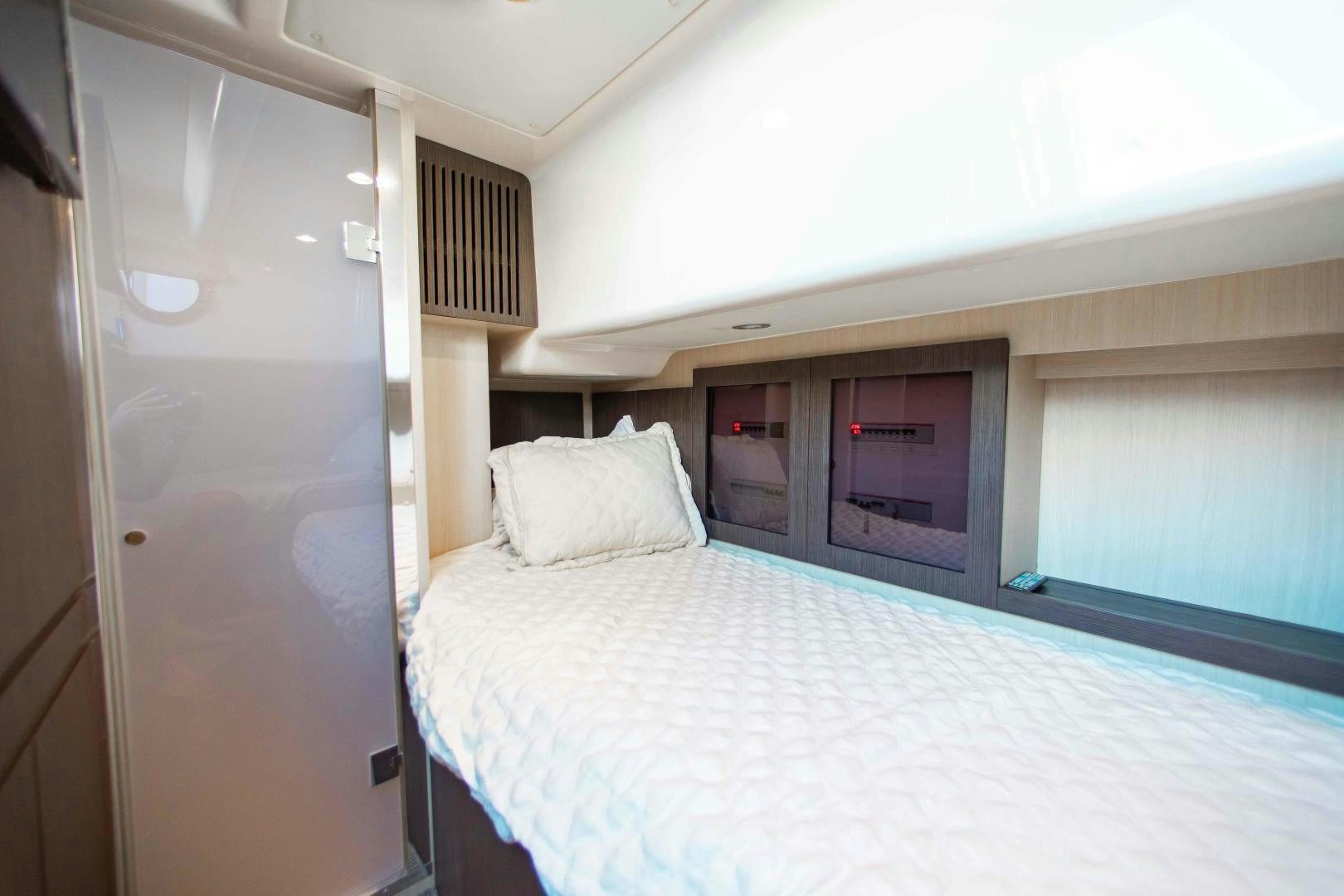 a bed with a white sheet aboard Queen Mara Yacht for Sale
