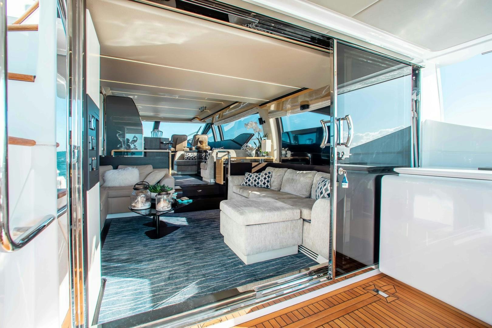 a person sitting in a chair in a room with a couch and a table aboard Queen Mara Yacht for Sale
