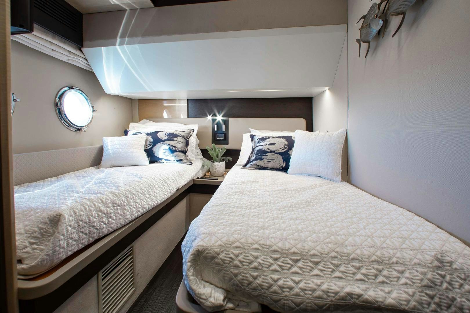 a couple of beds in a room aboard Queen Mara Yacht for Sale