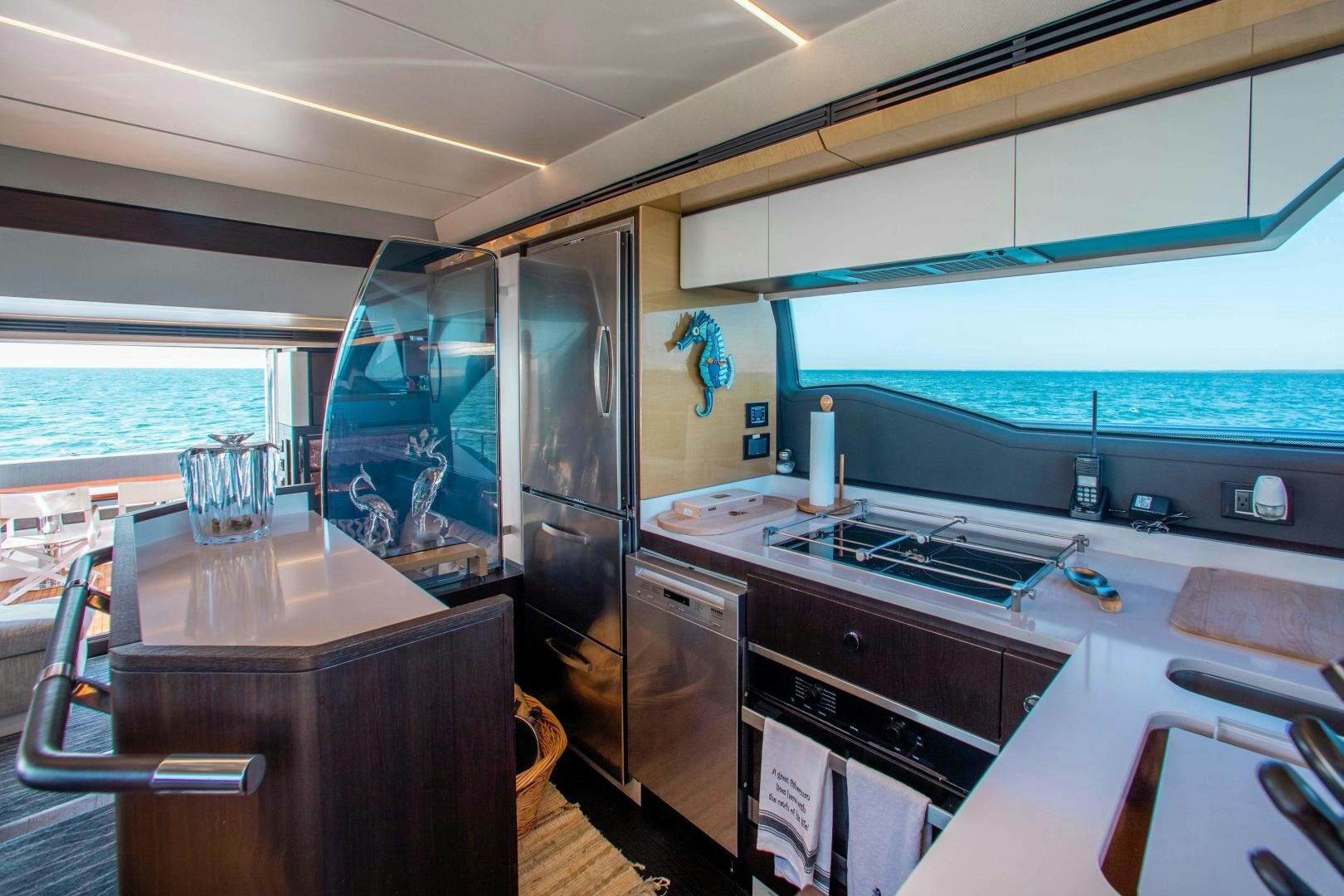 a kitchen with a glass door aboard Queen Mara Yacht for Sale