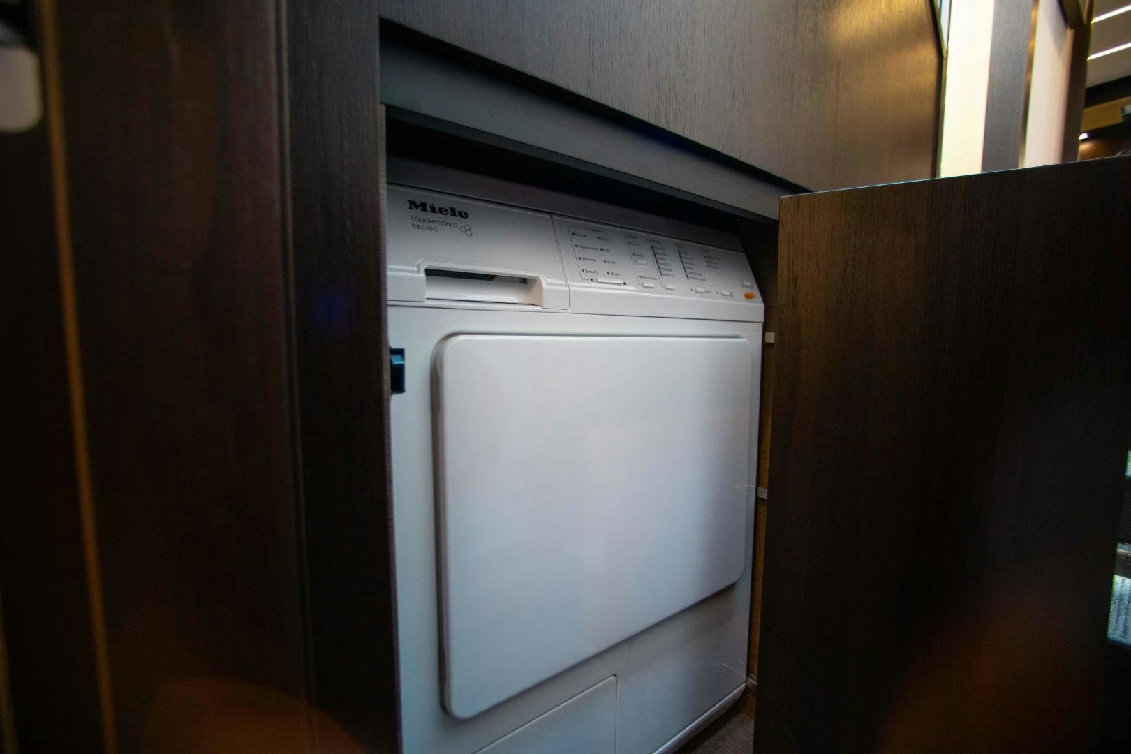a refrigerator next to a cupboard aboard Queen Mara Yacht for Sale