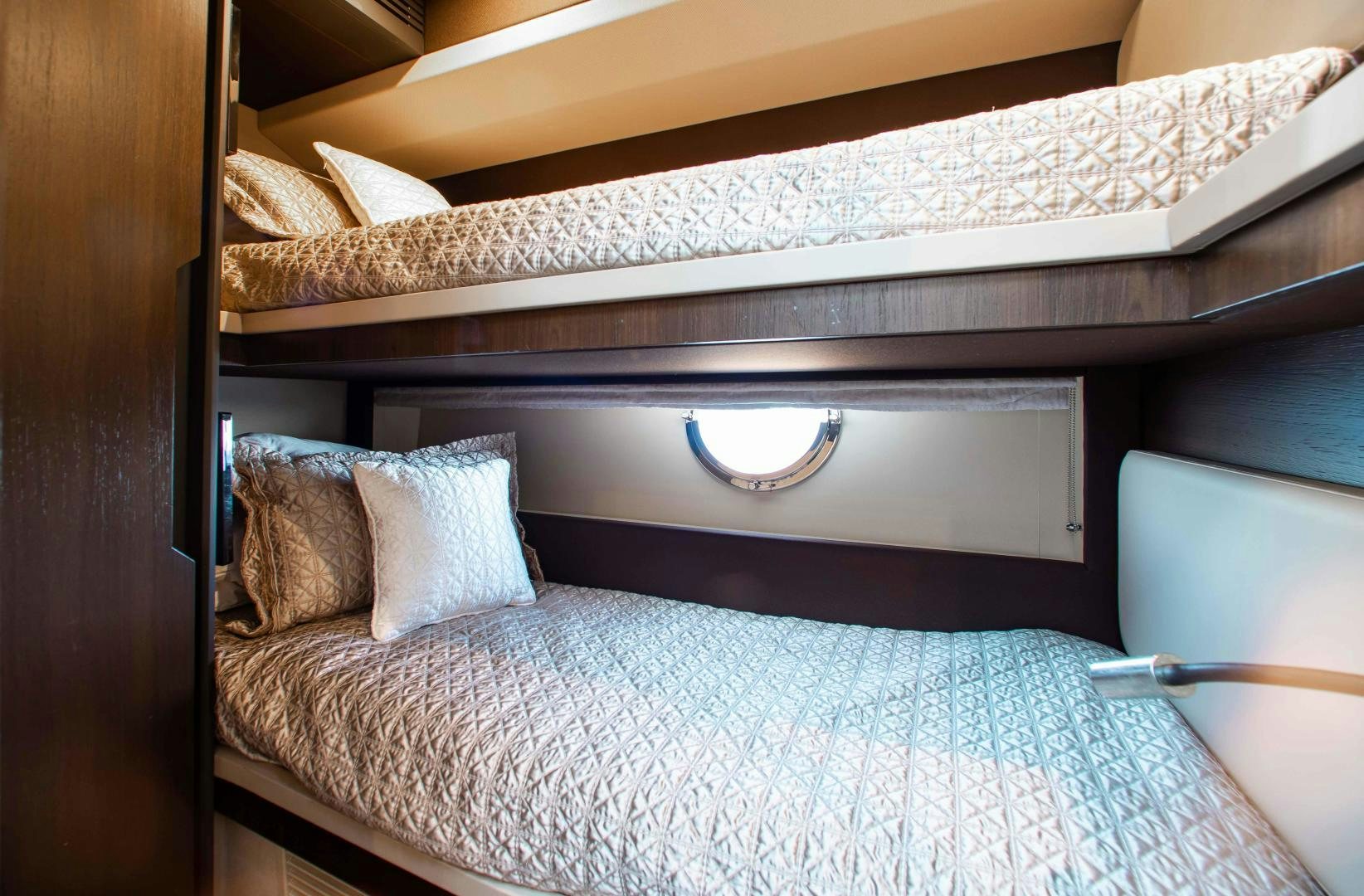 a bed with a white comforter aboard Queen Mara Yacht for Sale