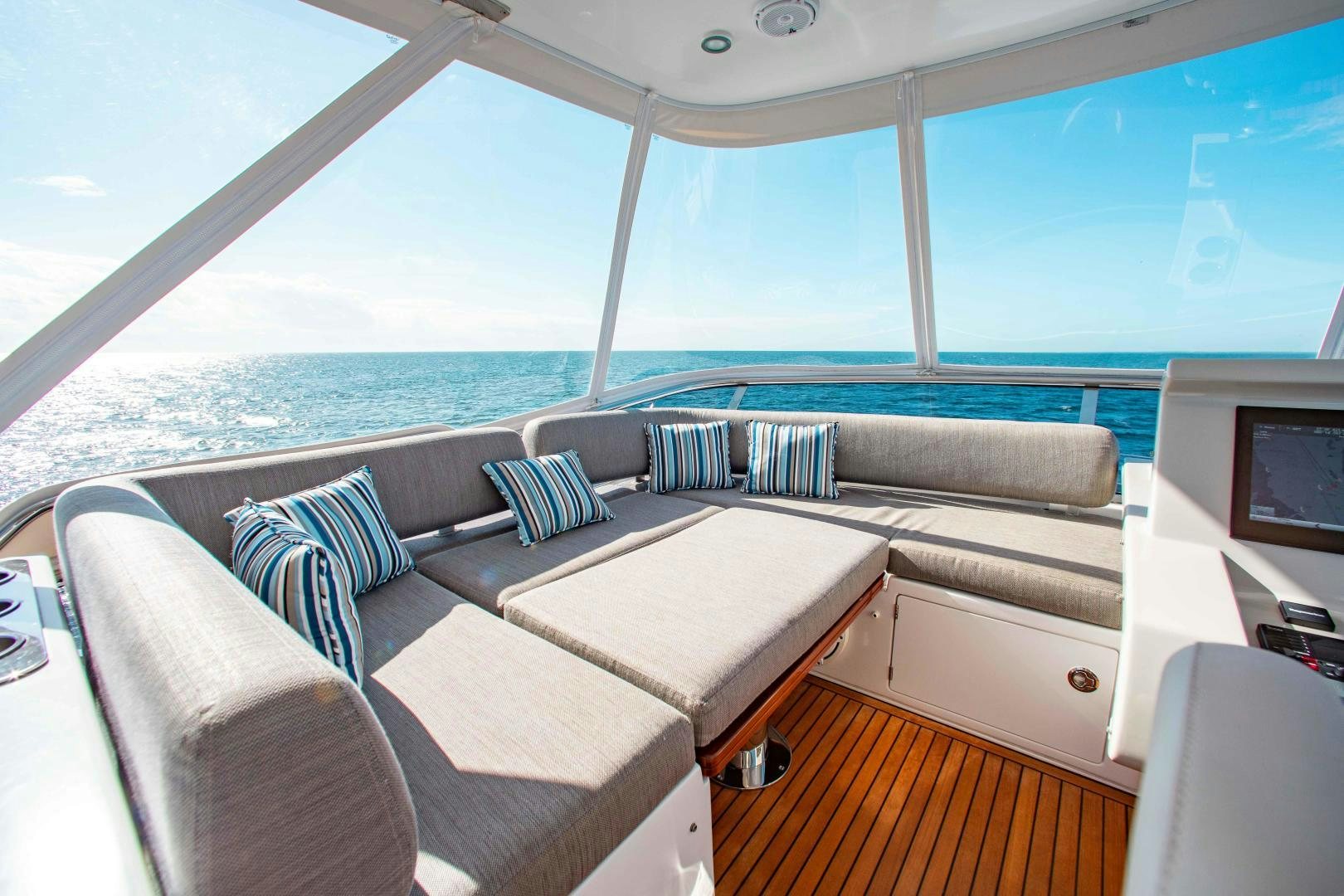 a large open area with a large window and a view of the ocean aboard Queen Mara Yacht for Sale