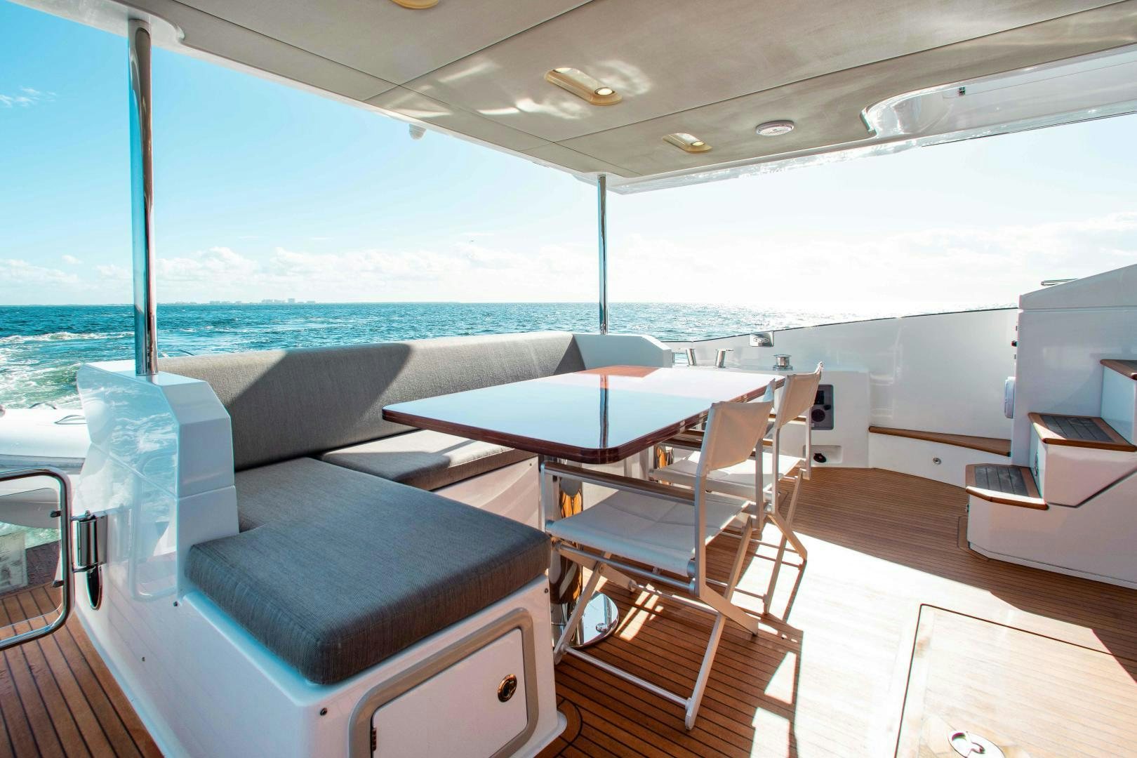 a room with a table and chairs aboard Queen Mara Yacht for Sale