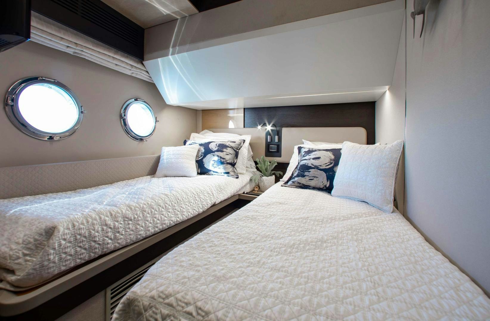 a couple of beds in a room aboard Queen Mara Yacht for Sale