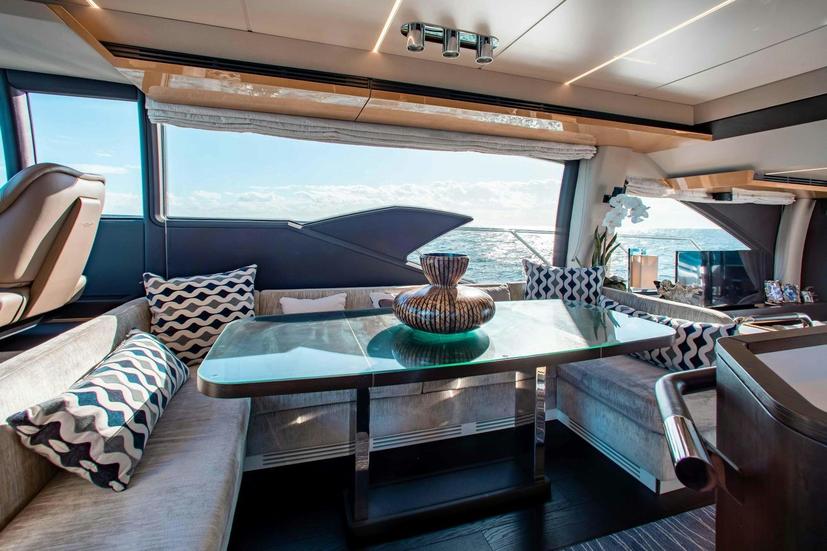 a room with a table and chairs aboard Queen Mara Yacht for Sale