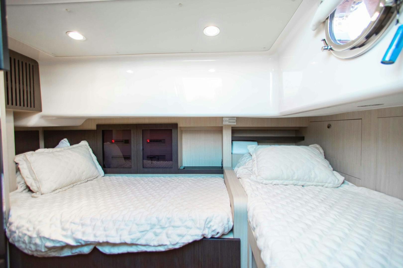 a room with two beds aboard Queen Mara Yacht for Sale