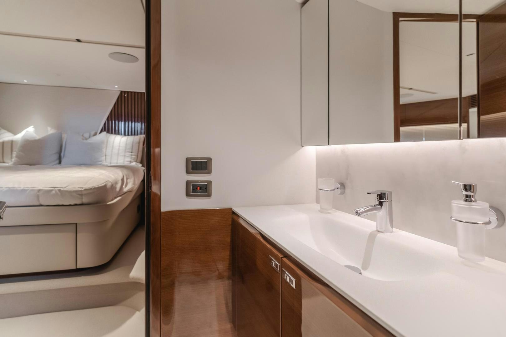 a bathroom with a sink and a bed aboard Mad Betty 2.0 Yacht for Sale