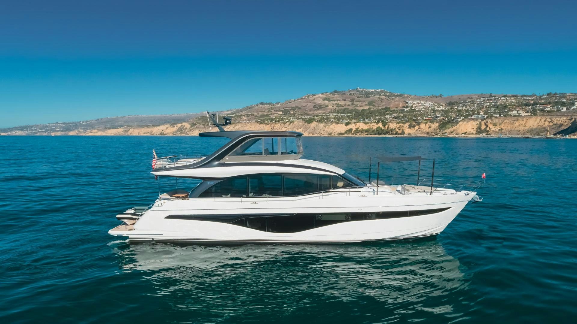 a white boat in the water aboard Mad Betty 2.0 Yacht for Sale