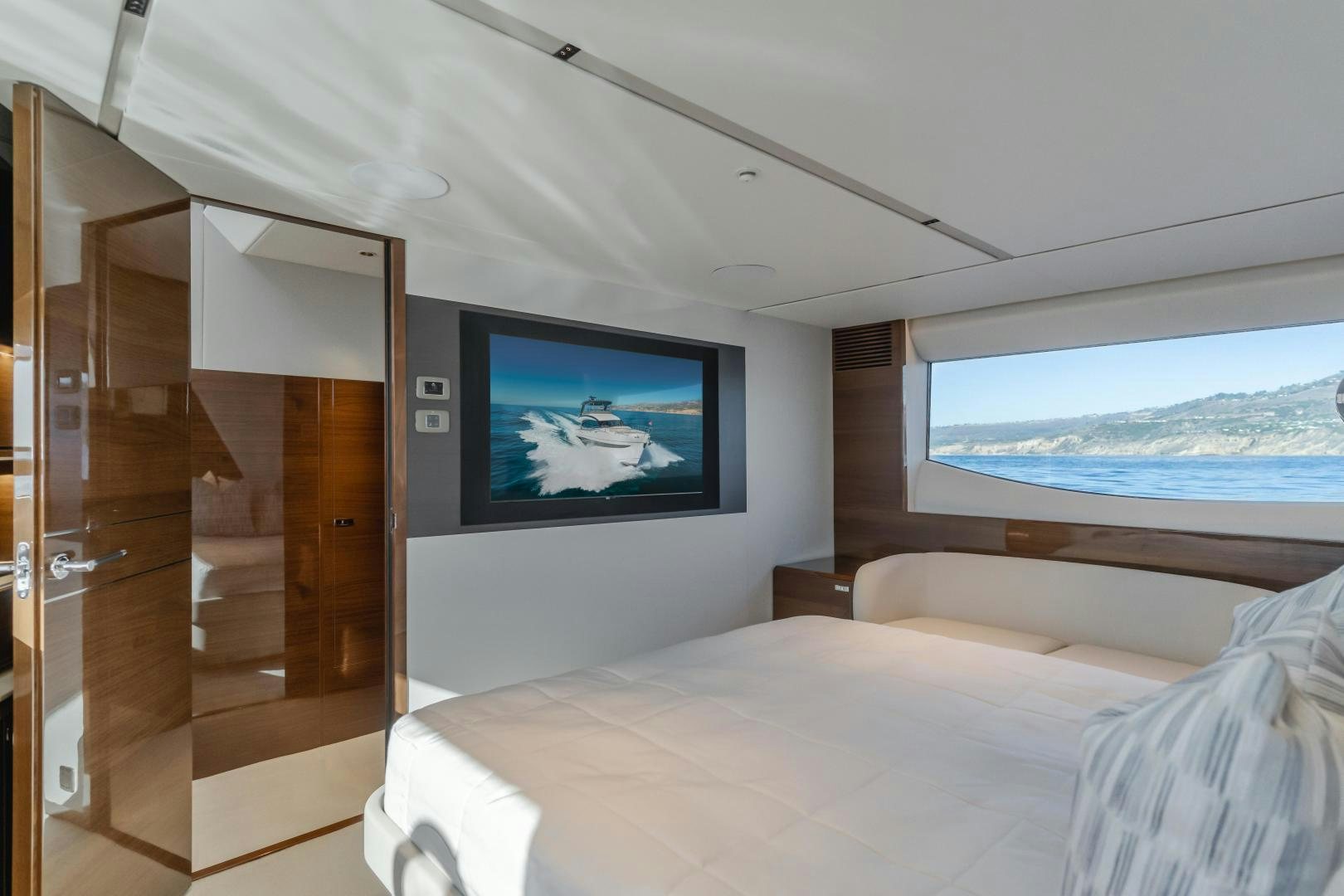 a room with a bed and a television aboard Mad Betty 2.0 Yacht for Sale