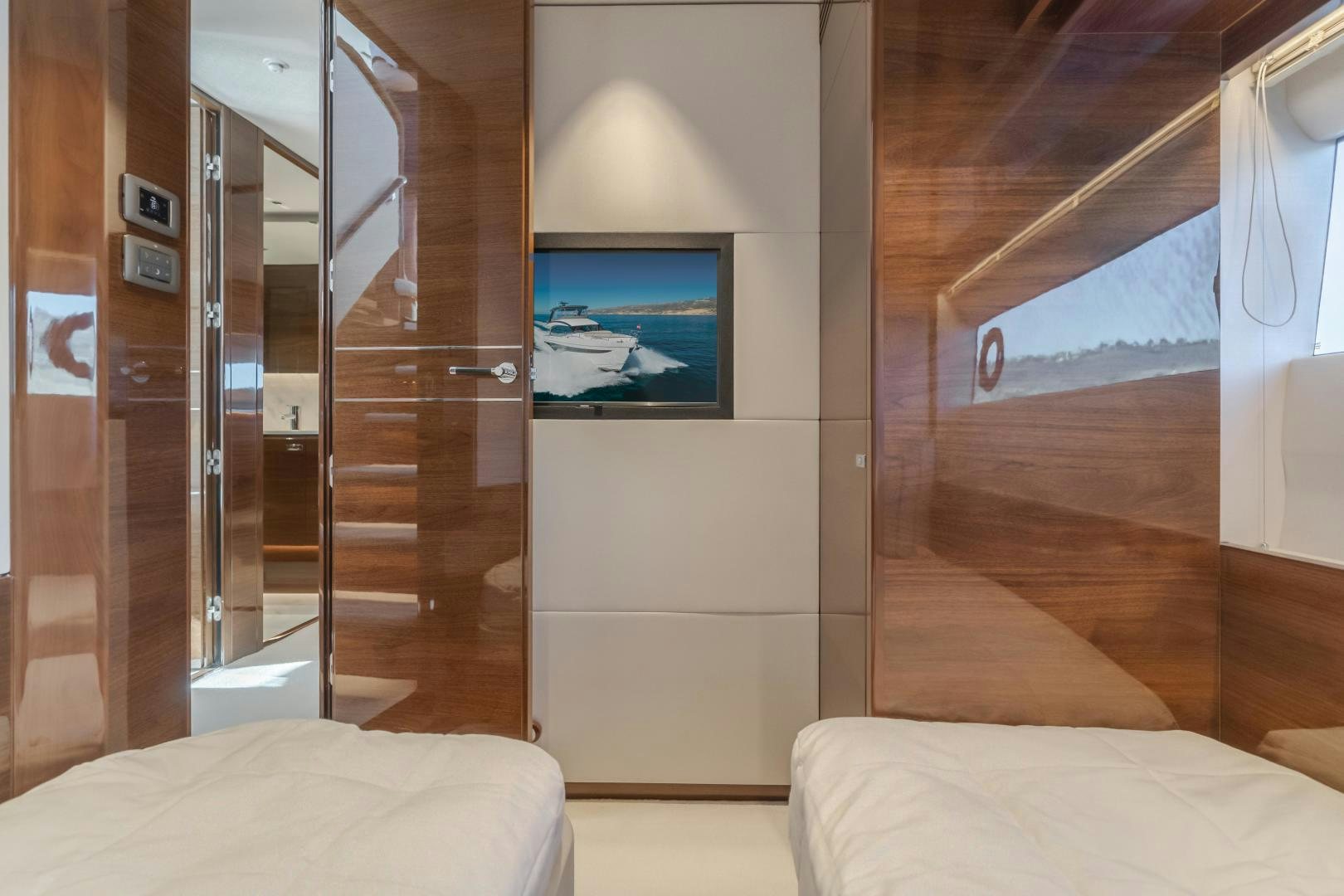a room with a bed and a television aboard Mad Betty 2.0 Yacht for Sale